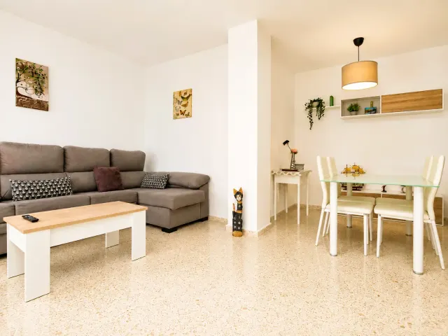 BookNoFees: Ferienwohnung in Jerez De La Frontera – Wohnzimmer mit grauem Sofa und Essbereich mit Glastisch